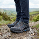 Man wearing Steen men's waterproof walking shoes while walking along a countryside trail in the UK.